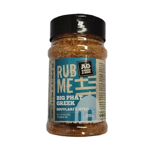 Angus & Oink Big Phat Greek seasoning tub beside grilled chicken and lemony herb-roasted veg