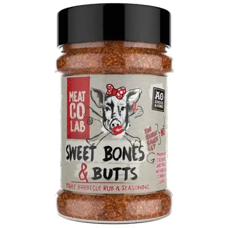 Angus & Oink Sweet Bones & Butts seasoning tub beside glazed BBQ pork ribs and pulled pork buns
