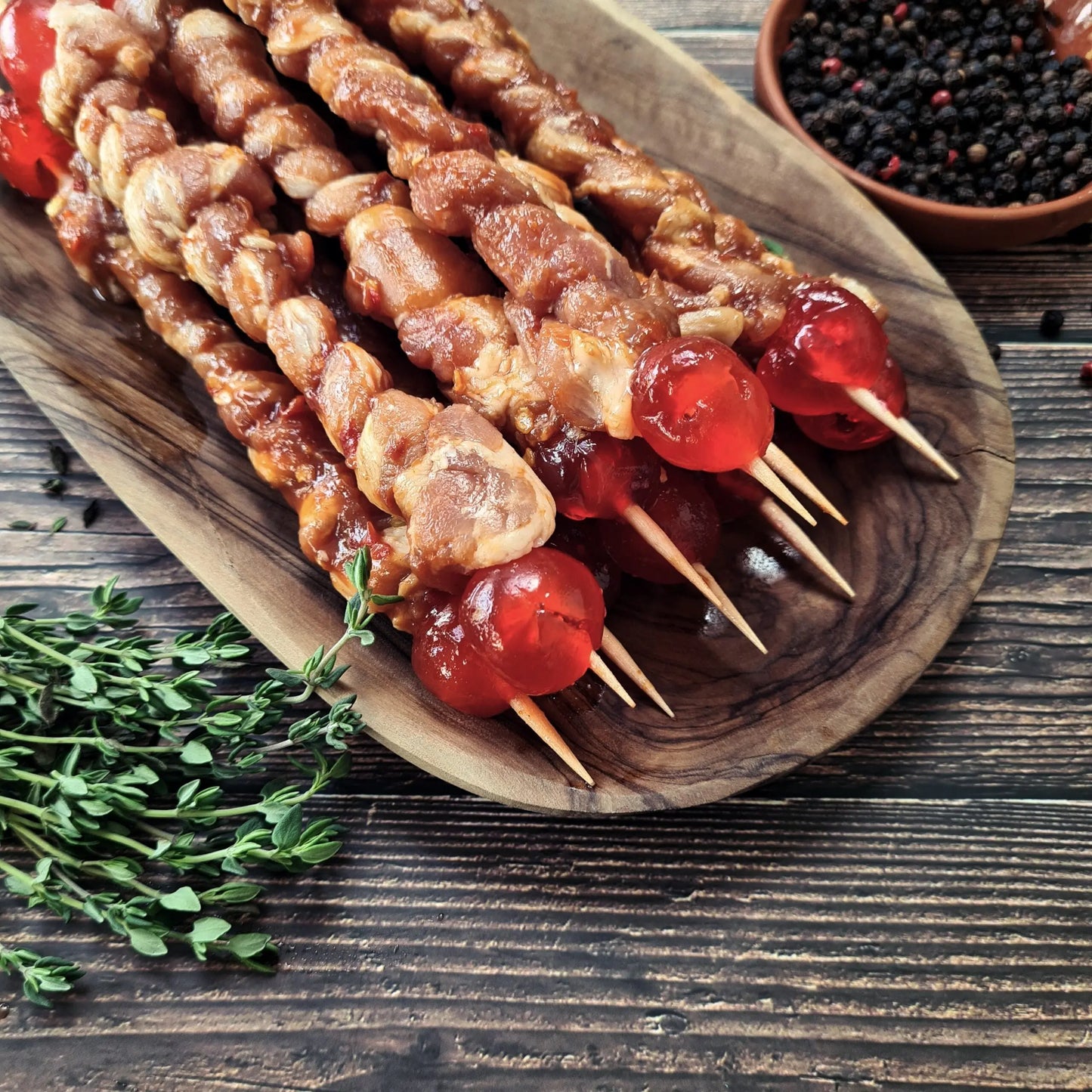 Bacon twizzlers (Oepsies) cooked to golden, crispy spirals on skewers, ready to serve with a maple glaze