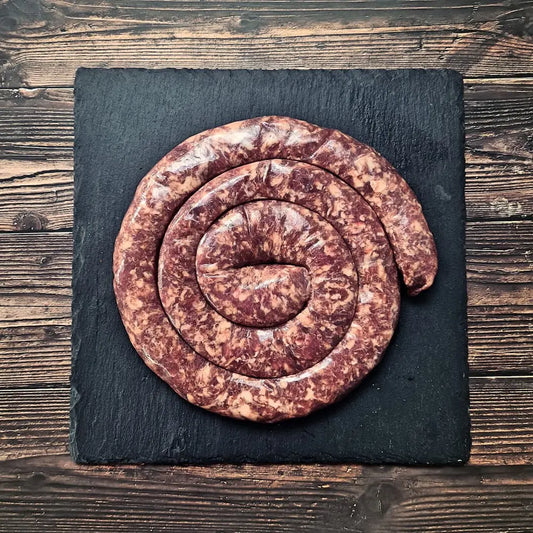 Boerewors sausage cooked as a spiral on the BBQ with a deep brown crust, ready to slice and serve – Uncle Beef Butchers