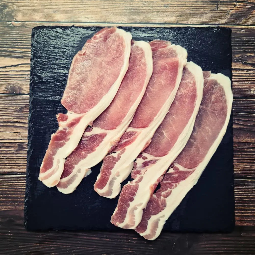 Dry cured unsmoked back bacon fried until evenly crisp with golden edges, stacked in a warm buttered roll
