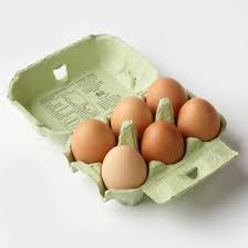Free range eggs in a recycled cardboard carton with rich golden yolks, ready for breakfast or baking