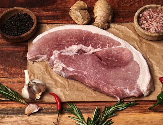 Gammon steaks seared to a caramelised crust, topped with a fried egg and served with chips and peas