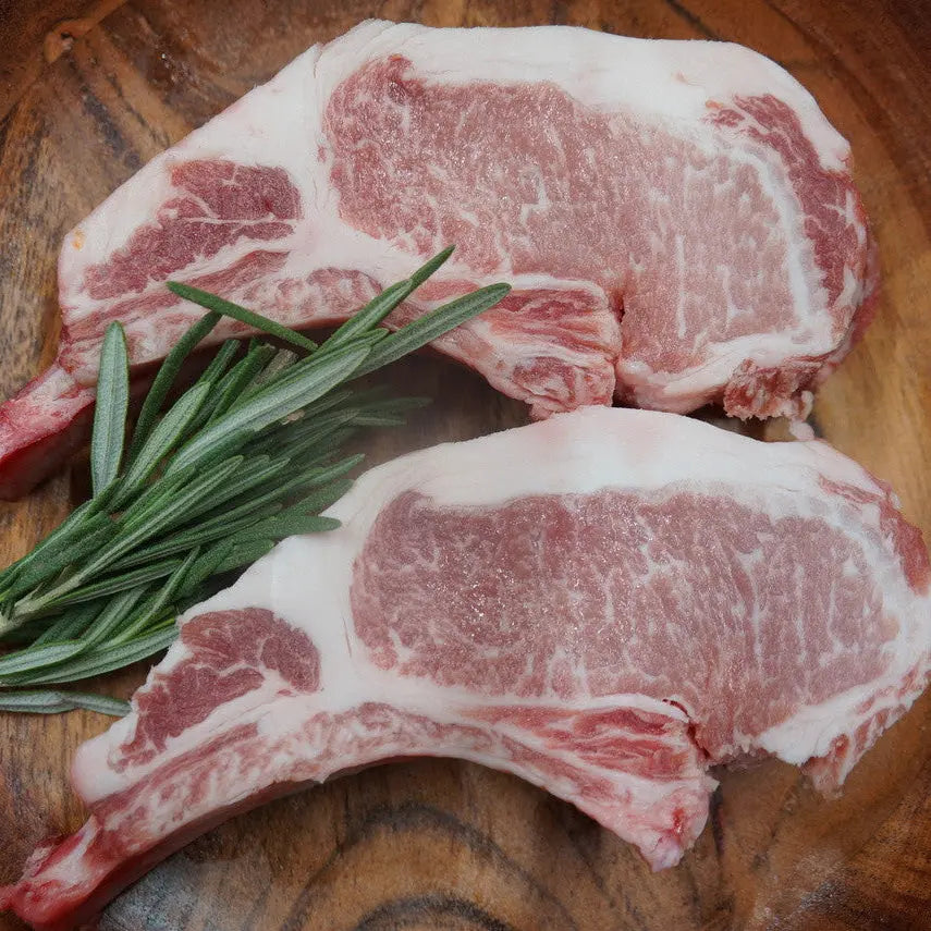 bérico pork chops with rich marbling seared to a golden crust, resting with lemon and herbs – Uncle Beef Butchers