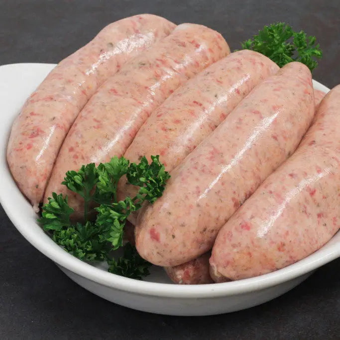 Kent hop and ale sausages browned in a pan, served with mash and ale–onion gravy