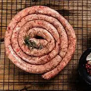 Lamb boerewors cooked as a spiral on the BBQ, browned and juicy, ready to slice and serve