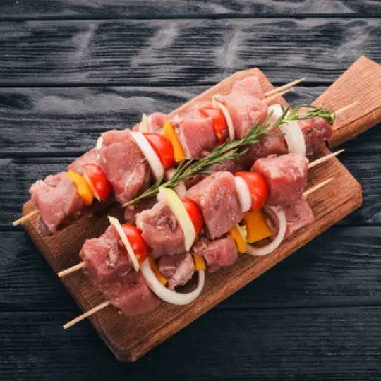 Pork kebab skewers charred on the grill, served with flatbreads, salad and garlic yoghurt – Uncle Beef Butchers