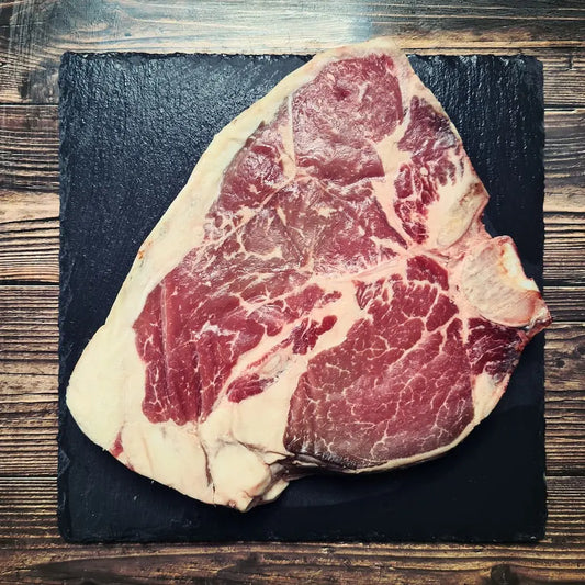 Porterhouse steak showing sirloin and large fillet, seared and ready to serve – Uncle Beef Butchers