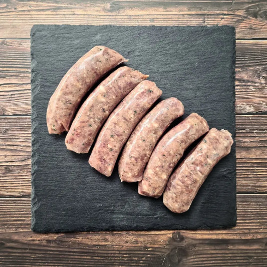 Toulouse sausages browned in a pan, served with lentils du Puy and Dijon mustard