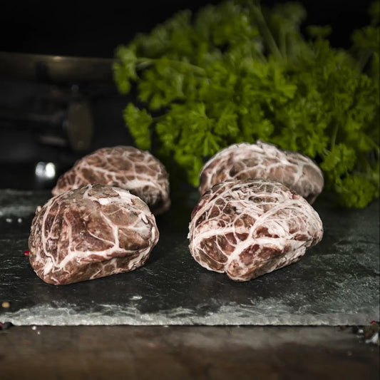 Traditional pork and liver faggots baked in rich onion gravy, served with mash and peas