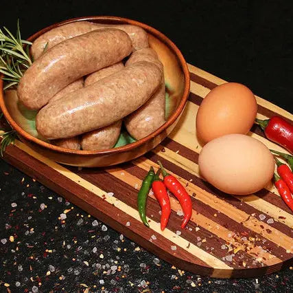 Welsh Dragon sausages browned in a pan with leeks and chilli, served with mash and onion gravy