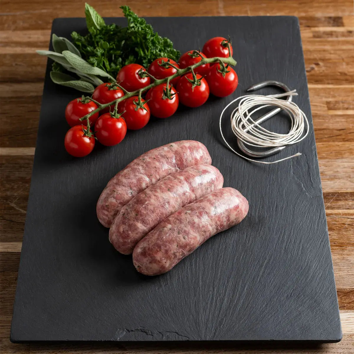 Wild boar and apple sausages browned in a pan, served with mash and cider–sage gravy